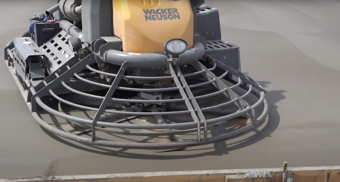 Professional concrete finishing with power trowel equipment in Tustin, CA